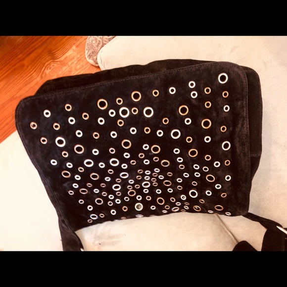 Black suede cross body handbag with metal Grommet design. Like new